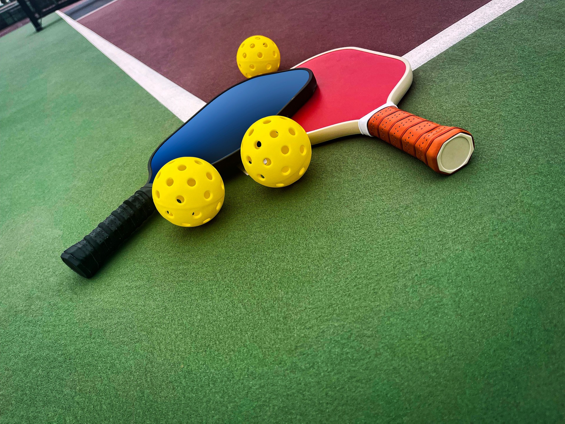 Pickleball Paddles and Balls on a court